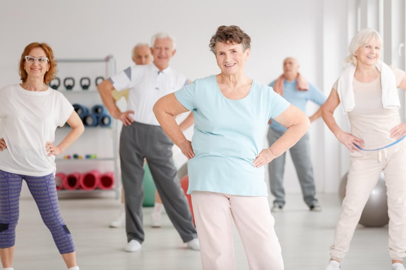 smiling senior multiethnic sportspeople fitness mats taking high fives